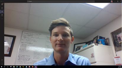 A man looks at the camera in a virtual meeting.